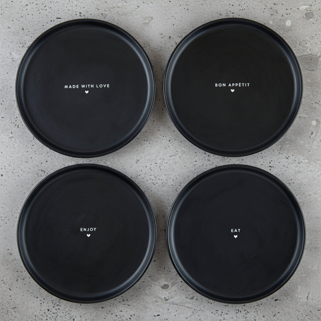 Four black plates with text on a white background