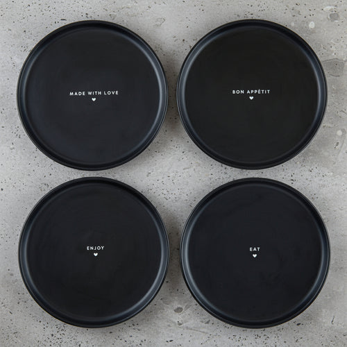 Four black plates with text on a white background